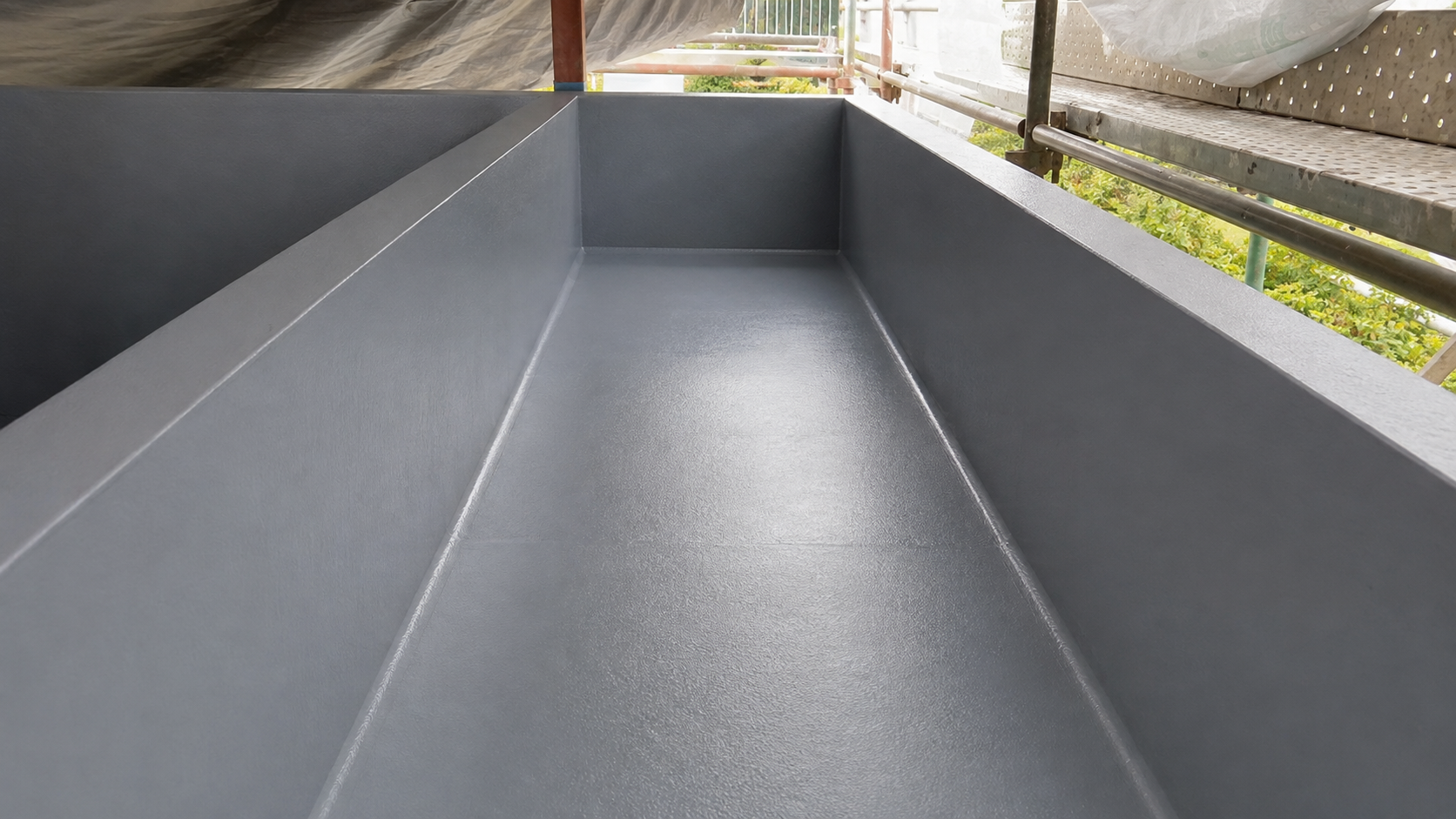 Completed flexible cementitious waterproofing inside concrete planters